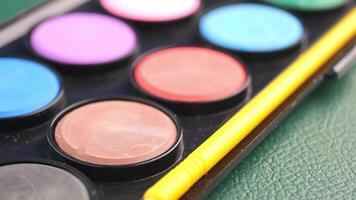 Colorful paint palette with brushes ready for creativity video