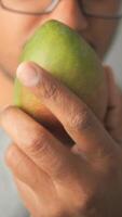Enjoying a fresh mango during a summer afternoon video