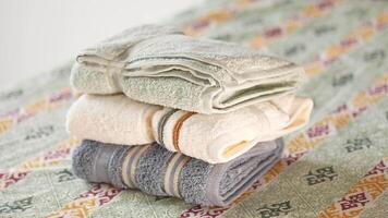 Neatly stacked towels on patterned surface at home video