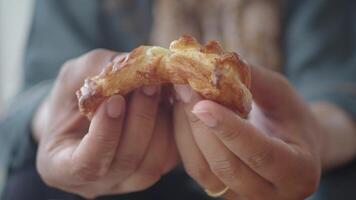 Enjoying a freshly baked pastry in a cozy cafe setting video
