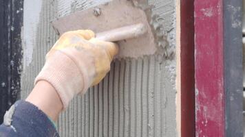 Mixing and applying plaster for wall finishing video