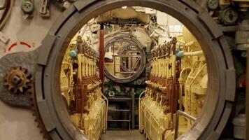 inside the submarine, open round strong hatchway in the engine room, zoom in video