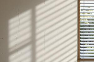Abstract Light and Shadow Play on Textured Wall with Venetian Blinds photo