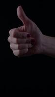Elegant female hand showcasing poise and sophistication in a minimalist setting with a dark background video