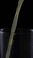 Freshly squeezed orange juice is poured into a clear glass creating a refreshing drink experience video