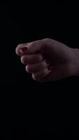 Elegant female hand displays sophistication in a minimalist setting with a dark background during an evening event video