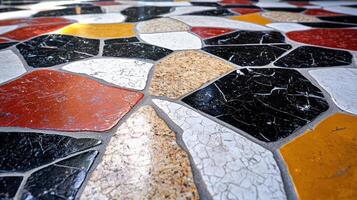 A mosaic tile floor with a variety of colors and shapes photo