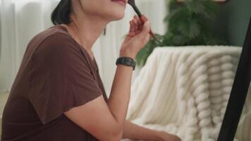 Woman Applying Foundation with Brush in Front of Mirror video