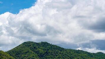 Time lapse of cloudy sky with mountains, nature view during daytime. Climate and weather concept video