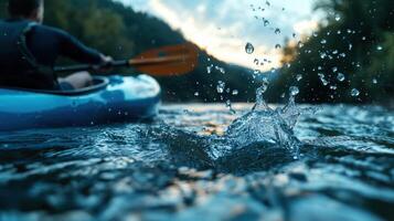 A man paddles a kayak through a river photo