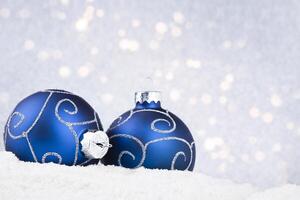 christmas background with blue balls on snow and bokeh photo