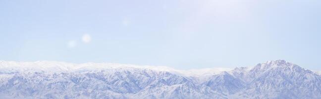 panoramic view of snowy mountains and clouds. photo