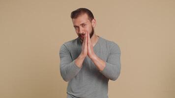 Man praying, looking upward, making wish, asking with hopeful imploring expression, begging apology video