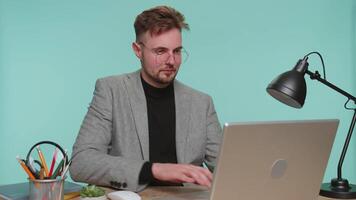 Satisfied successful business man at office looking into camera taking off glasses, happy smiling video