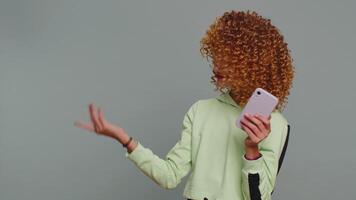 Girl using smartphone pointing empty place positive feedback recommends social networks application video
