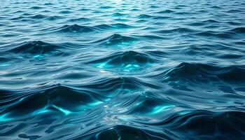 Serene Ocean Surface Reflecting Sunlight Creating Ripples and Waves in Deep Blue Water Background photo
