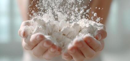 Hand holding flour ready to knead dough and bake fresh bread with soft natural light creating warm and inviting atmosphere photo