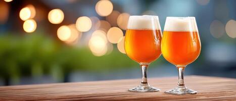 Two glasses of amber beer with foam on wooden table in warm evening light with blurred background creating cozy mood photo
