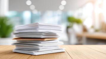 Stack of office documents on wooden desk with blurred background in bright workspace photo