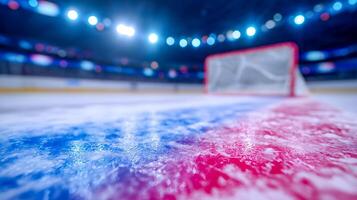 A low-angle view of an ice rink, showcasing a red and blue painted line leading to a goal net in the background, illuminated by bright arena lights. photo
