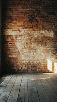 An empty room with a brick wall and wooden floor photo