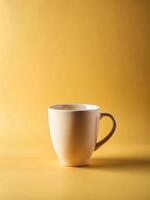 Beige ceramic mug with a handle, placed against a vibrant yellow background, casting a soft shado - Minimalist Beverage Concept photo
