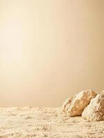 Textured beige surface with rock formations in the foreground against a uniform backdrop photo