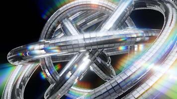Spinning metallic torus rings with rainbow light dispersion and glossy reflections in abstract 3D background video