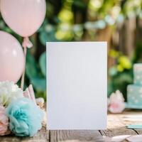 zBlank invitation at a party with pink balloons, colorful flowers, and a wooden table photo