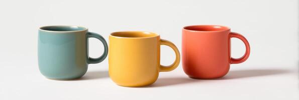 Trio of mugs, A pleasing composition of ceramic mugs in various colors, arranged in a simple and elegant arrangement on a white background. photo