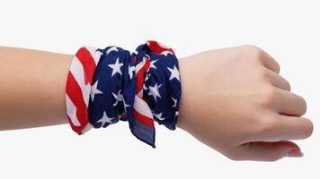 Hand wearing American flag bandana on white background photo