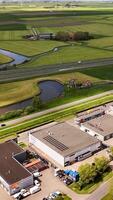 Aerial view of a large industrial building with a large field video