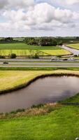 A river runs through a field and a highway video