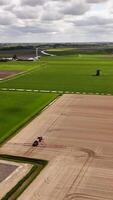 Aerial view of a tractor spraying a field video