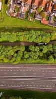 Aerial view of a road with houses and trees video