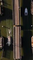 Aerial view of boats in the water at a bridge video