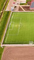 Aerial view of a soccer field with a solar panel video