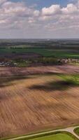 Aerial view of a field with a road in the middle video