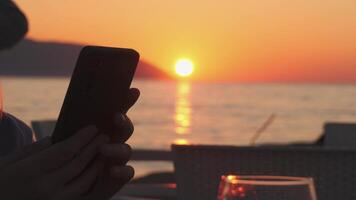 On smartphone at a Resaturant with Seaside Sunset, Digital distraction scene video