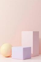 A minimalist display features a pale yellow sphere and a light purple cube resting on a soft pink cube against a matching seamless background photo