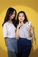 Two Generation Z Girl Taking Selfie Together using Smartphone photo