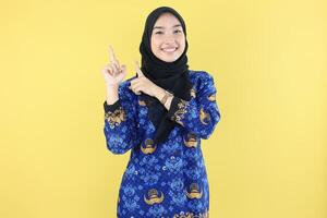 Indonesian teacher ASN or PNS in Batik Korri Pointing at Copy Space photo