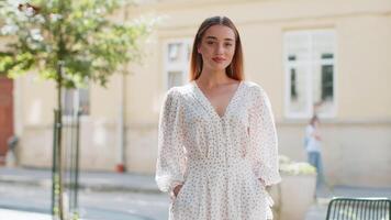 Portrait of happy woman stands with her back turns around smiling, glad expression looking at camera video