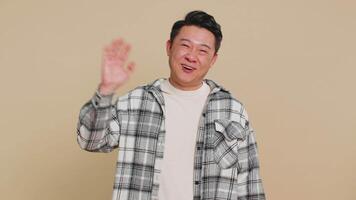 Happy man smiling friendly waving hands gesturing hello greeting or goodbye, meeting invitation video
