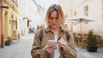 Woman using credit bank card and smartphone while transferring money, purchases online shopping video