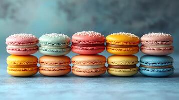 Colorful macarons arranged neatly on a blue background showcasing intricate designs and vibrant hues photo