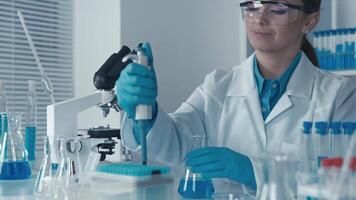 In a modern laboratory equipped with stateoftheart scientific tools, a highly skilled lab technician is meticulously using a micropipette to perform precise experiments in the field of science video