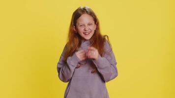 Happy excited child girl laughing out loud after hearing ridiculous anecdote, reaction on funny joke video