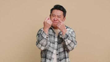 Angry aggressive Asian man showing fig negative gesture, refusal fig sign, rapacious, avaricious video