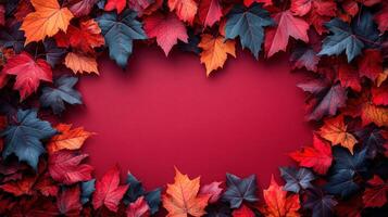 Colorful autumn leaves create a vibrant border on a red background, highlighting the seasonal beauty of nature photo